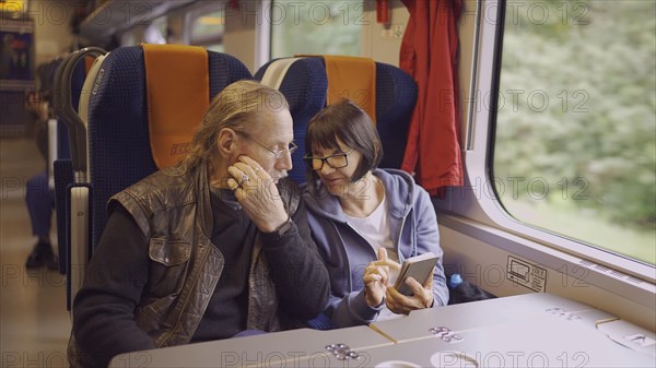 Elderly couple travel by train