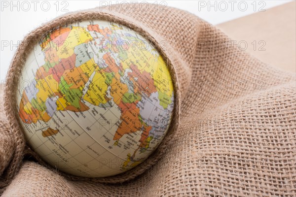 Linen canvas is wrapped around a model globe