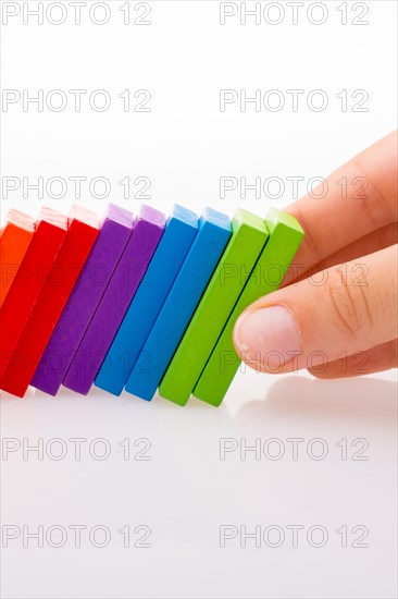 Hand holding color dominoes on a white background