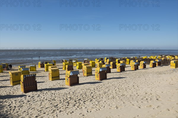 Yellow beach chairs and mudflats