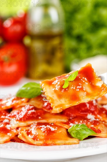 Ravioli Italian pasta in tomato sauce eat with fork lunch dish on plate in Stuttgart