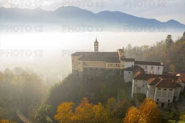 Monastery Madonna del Sasso in the Fog with Sunlight in Locarno