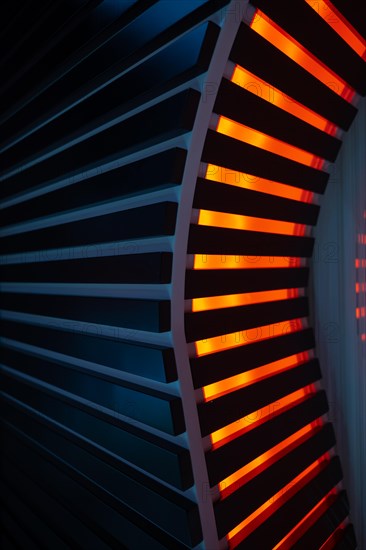 Illuminated Orange Stripes on a Modern Column in Switzerland