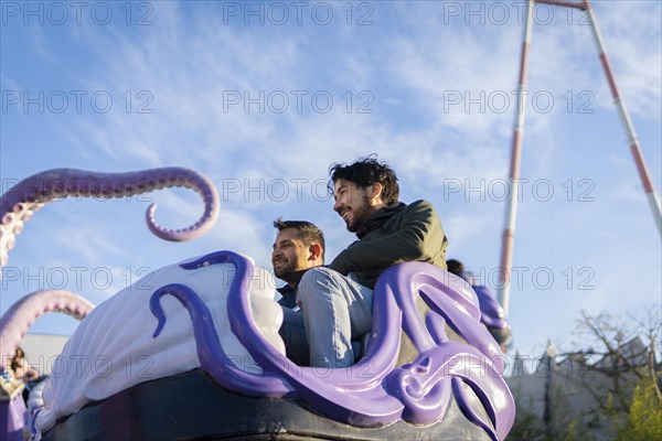 Couple of latin friends having fun in an amusement park