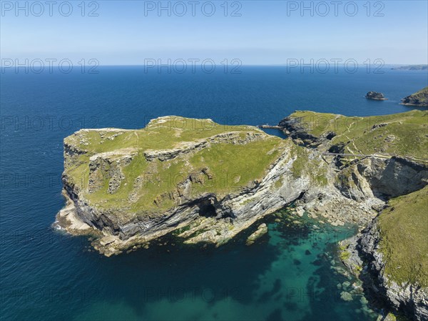 Aerial view of the rugged coastline on the Celtic Sea with the Tintagel Peninsula and the ruins of Tintagel Castle