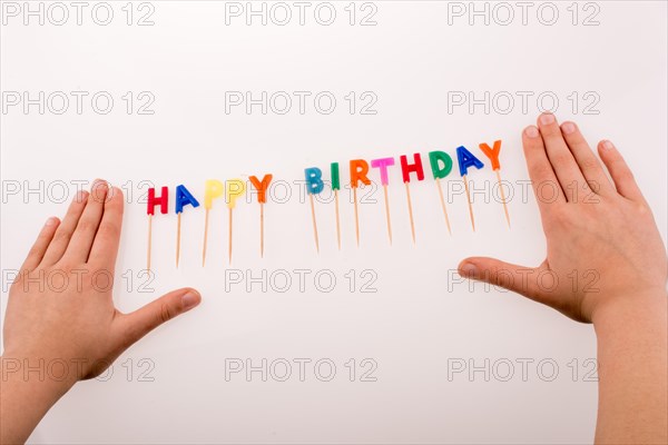 Hand and color candles on sticks write the words happy birthday
