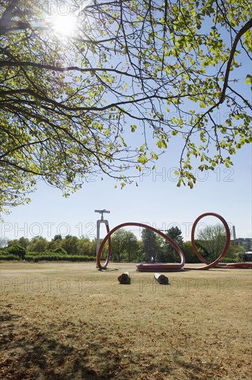 Withered meadow and sculpture of a water tap