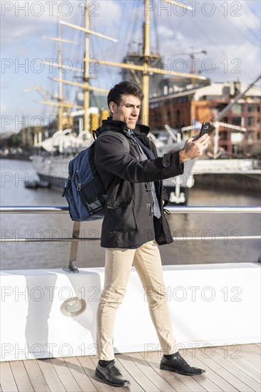 Handsome tourist taking selfies in Puerto Madero