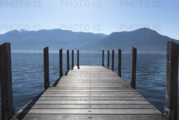 Pier on an alpine lake Lago Maggiore