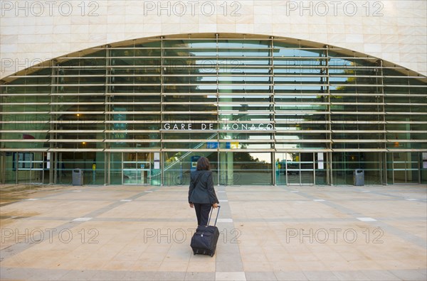 Elegant Woman with Her Suitcase in Front of Railroad Staion in Monte Carlo
