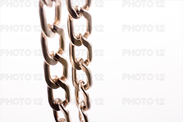 Gold color metal chain on white background