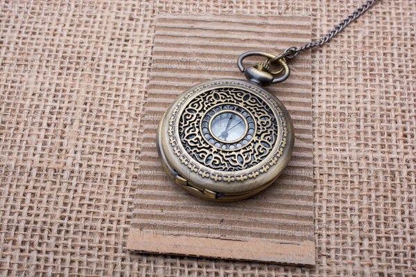 Mechanical pocket watch on linen canvas