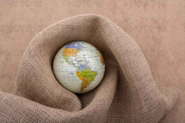 Linen canvas is wrapped around a model globe