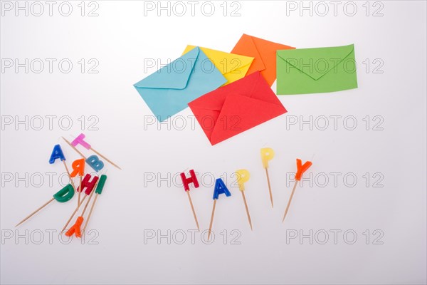 Colored envelopes and Color candles on sticks write happy