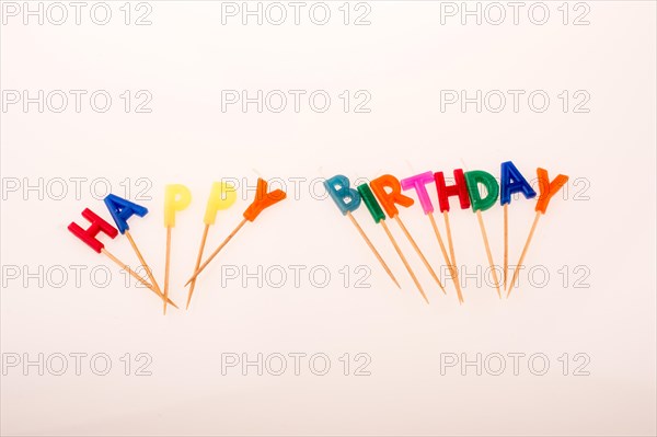 Color candles on sticks write the words happy birthday