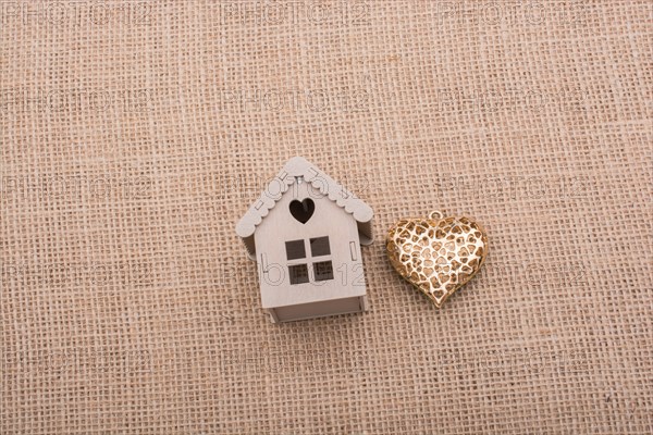 Heart shaped icon and model houses on a brown background