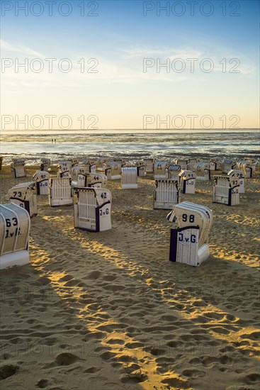 White beach chairs and mudflats