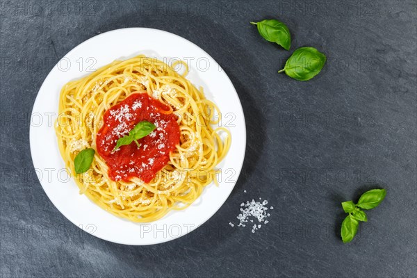 Spaghetti eat Italian pasta lunch dish with tomato sauce from top of slate in Stuttgart