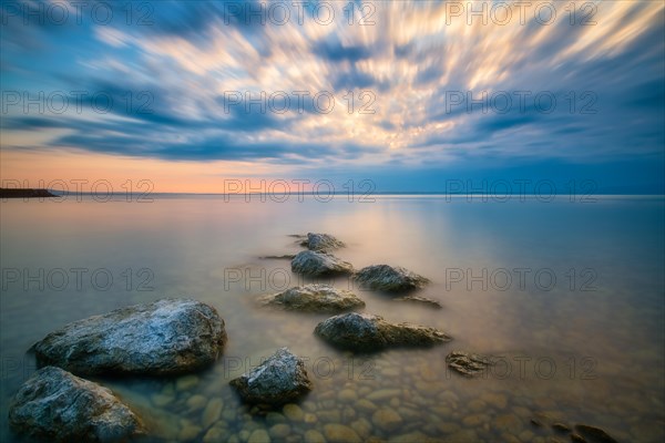 Atmospheric clouds at sunrise on Lake Constance