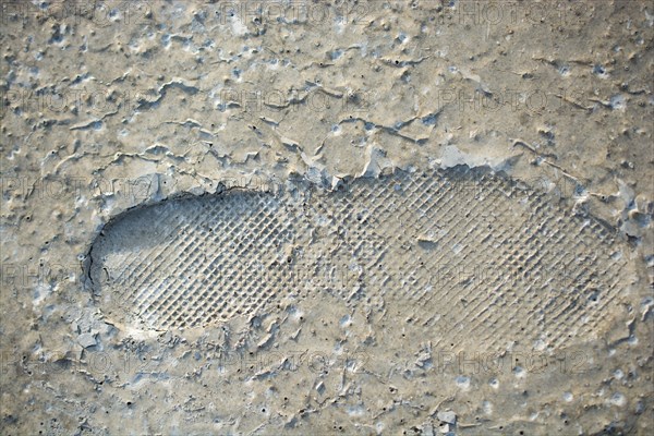 Footstep pattern seen on a concrete background