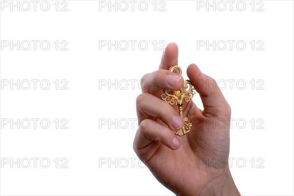 Hand holding a retro styled metal key on a white background