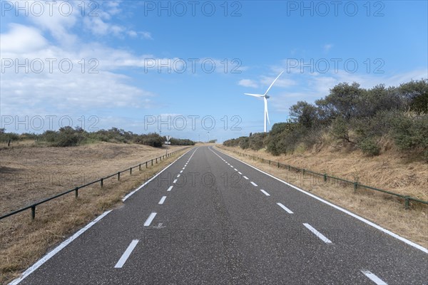 Access road to Banjaard beach with wind turbines of the Oosterschelde Barrage