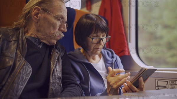 Elderly couple travel by train