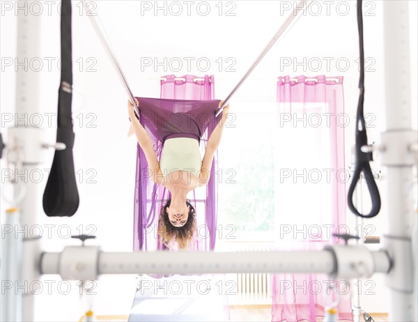 Woman Exercising on Pilates Machine with Transparent Skirt