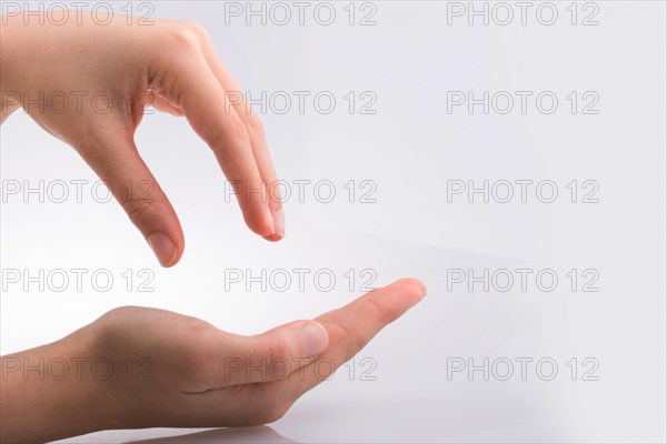 Hand holding gesture made on a white background