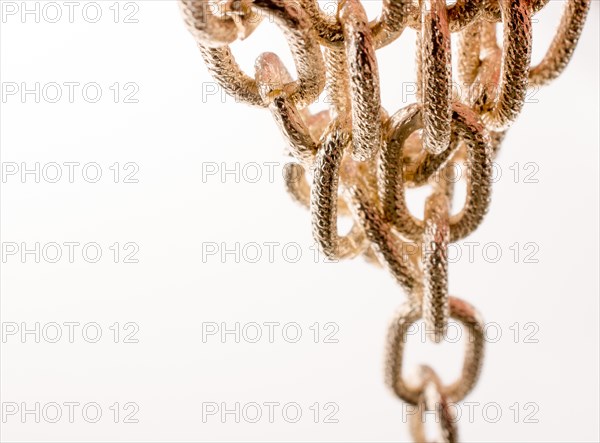 Gold color metal chain on white background