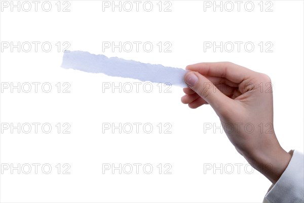 Hand holding a piece of blank torn notepaper