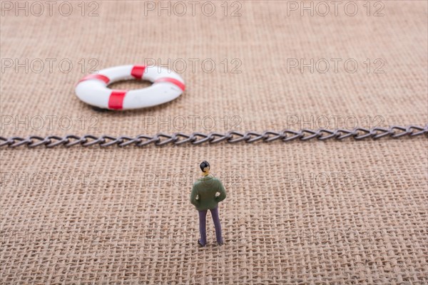 Figurine and life preserver with with a chain in the middle them