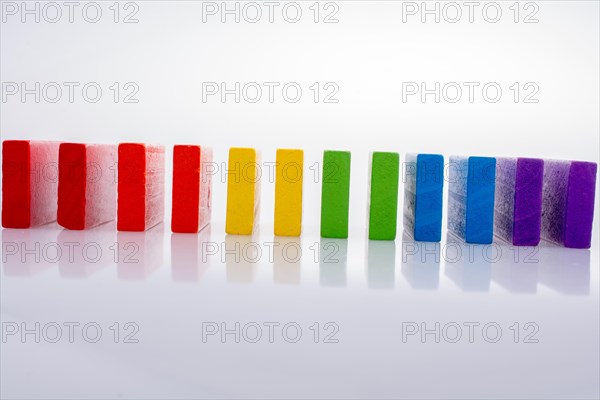 Colorful Domino Blocks in a line on a white background