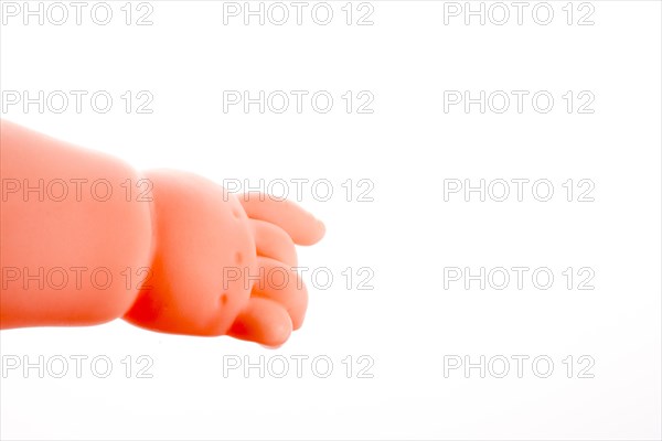 Baby doll's legs on a white background