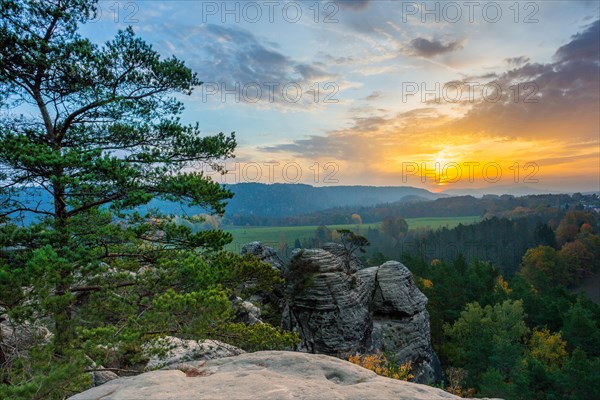 Sunrise in the mountains with a rocky peak in the foreground