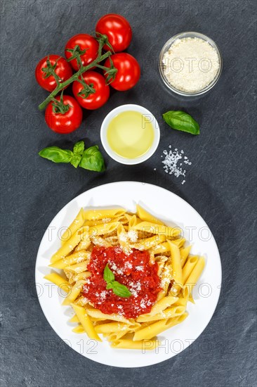 Penne Rigatoni Rigate Italian pasta in tomato sauce eat lunch dish on plate slate from above in Stuttgart