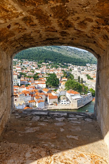 View of the old town through an opening in the wall of the fortress in Dubrovnik