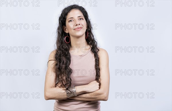Portrait friendly latin girl in white background. Beautiful latin woman with arms crossed isolated. Nicaraguan woman on isolated background