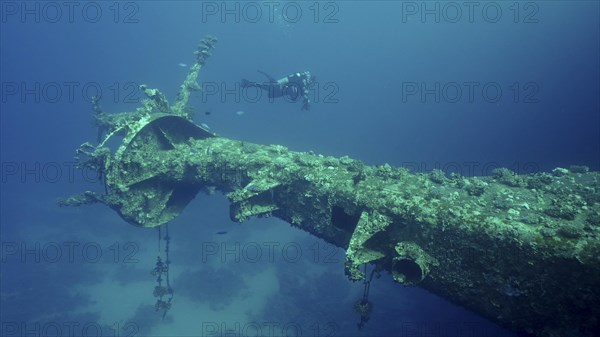 Scuba diver swim next to mast of ferry Salem Express shipwreck