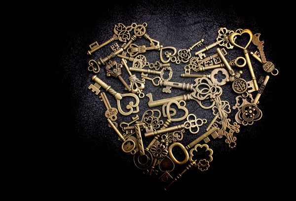 Retro metal keys form a heart shape on black