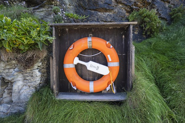 Lifebelt with lifebuoy on a rock face near Tintagel Castle