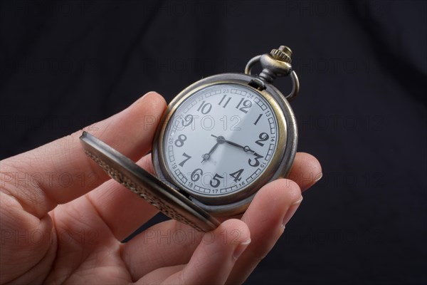 Retro style pocket watch on a dark background