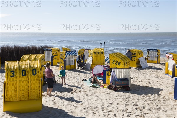 Yellow beach chairs and mudflats