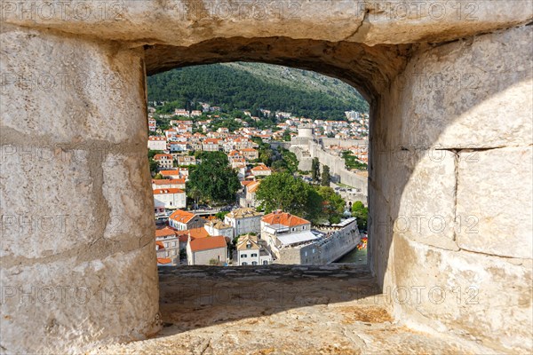 View of the old town through an opening in the wall of the fortress in Dubrovnik