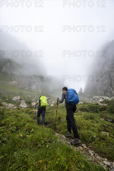 Mountaineers climbing in the fog