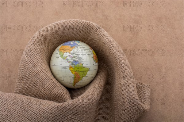 Linen canvas is wrapped around a model globe