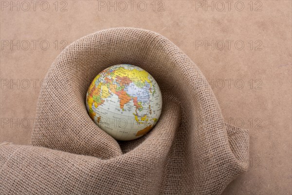 Linen canvas is wrapped around a model globe