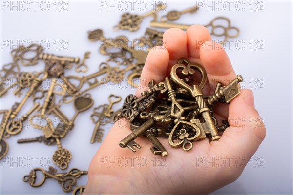 A handful retro style metal keys on white background