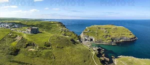 Aerial panorama of the rugged coastline on the Celtic Sea with the Tintagel Peninsula and the ruins of Tintagel Castle