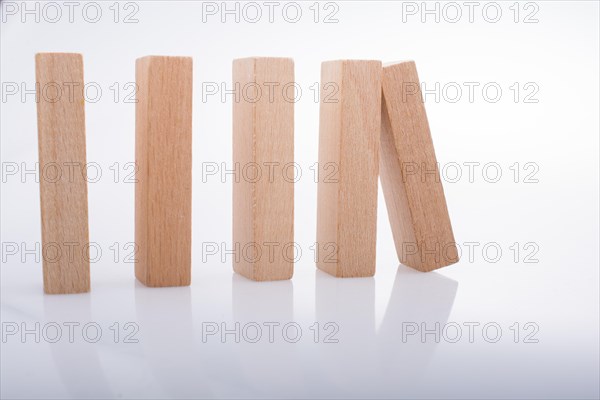 Wooden Domino Blocks in a line on a white background